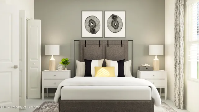 a bedroom with a bed and painting on the wall