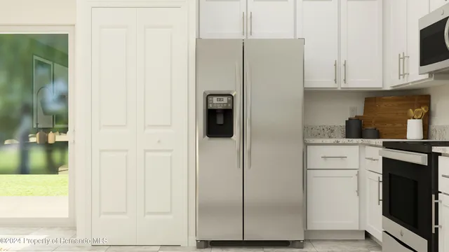 a kitchen with a refrigerator and cabinets