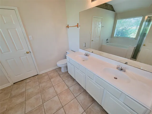 a spacious bathroom with a bathtub sink and toilet