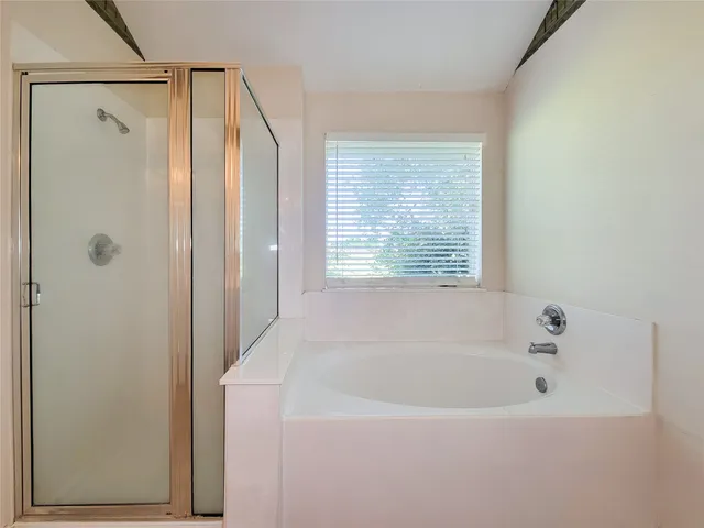 a white bath tub sitting next to a window