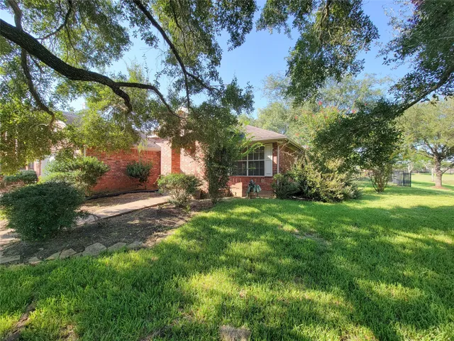 a view of a tree in front of a house