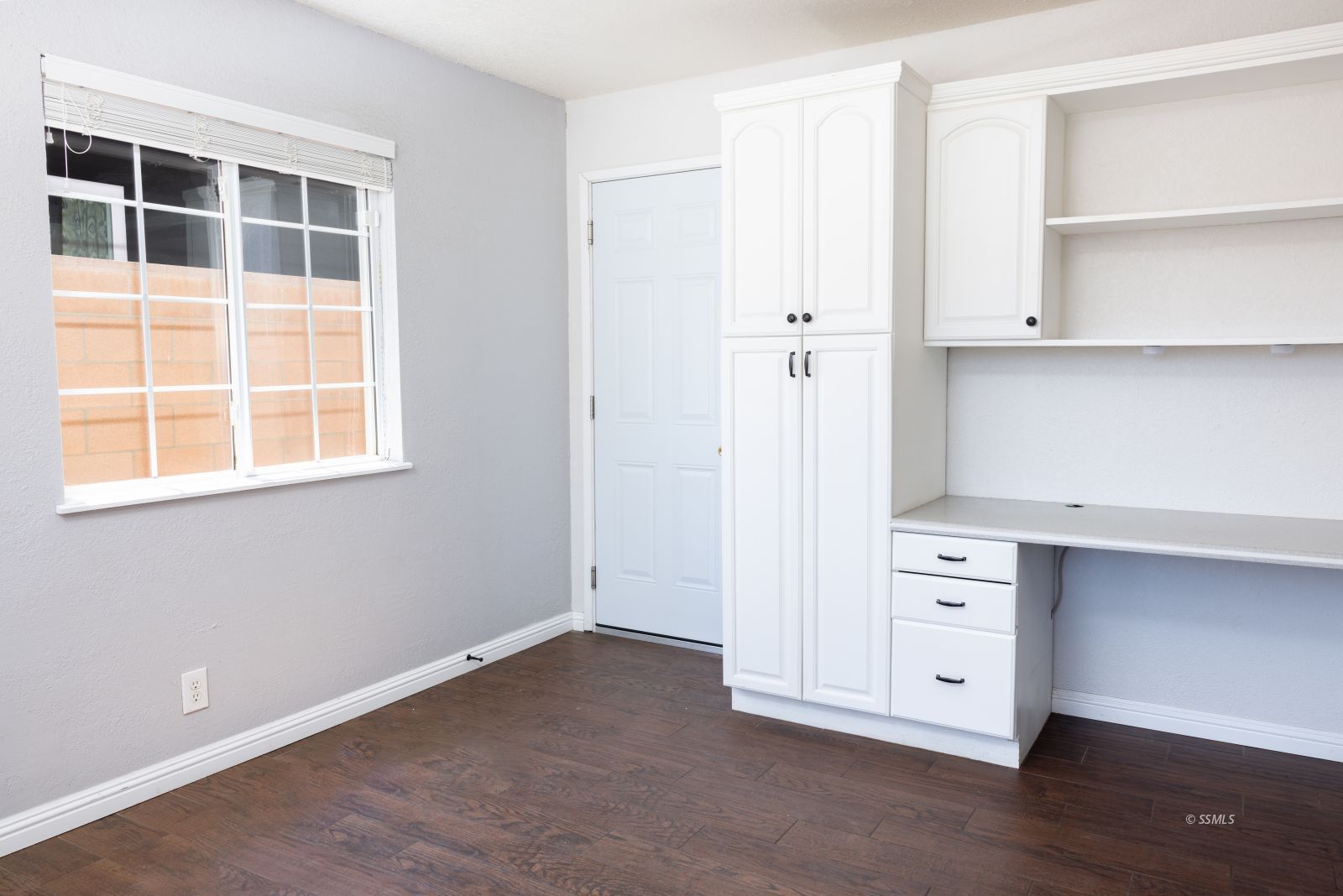 542 South Warner Street Ridgecrest, CA 93555 - Photo 13 of 33 a view of an empty room with a window and wooden floor