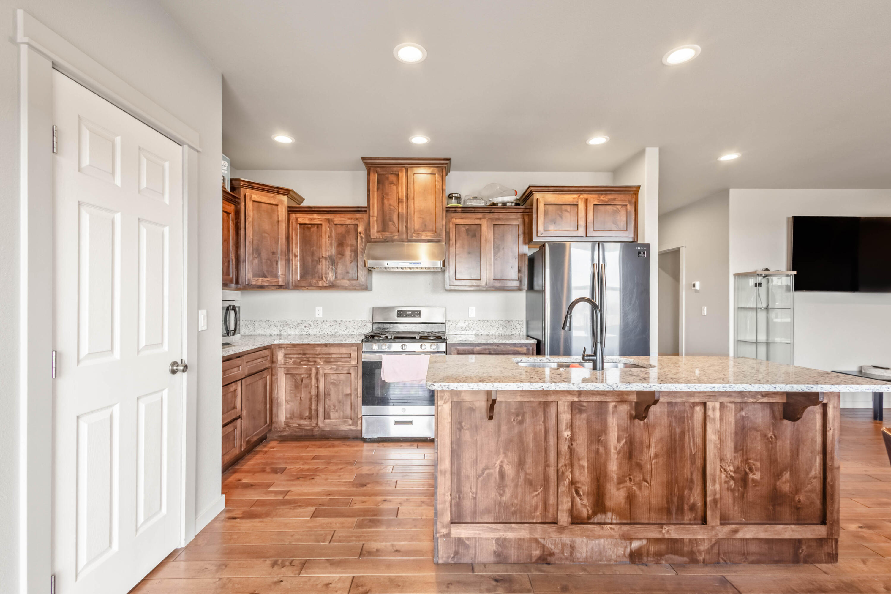 539 Leisek Way Madras, OR 97741 - Photo 7 of 35 a kitchen with stainless steel appliances kitchen island granite countertop a refrigerator and a stove top oven