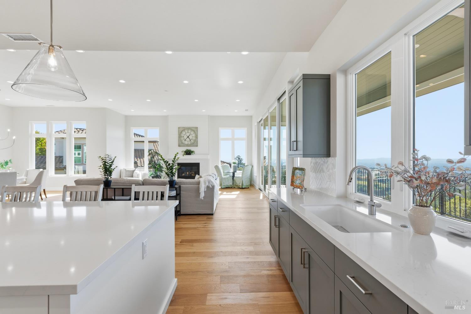3945 Parker Hill Road Santa Rosa, CA 95404 - Photo 20 of 53 a large living room with stainless steel appliances granite countertop lots of white cabinets a couch and wooden floor