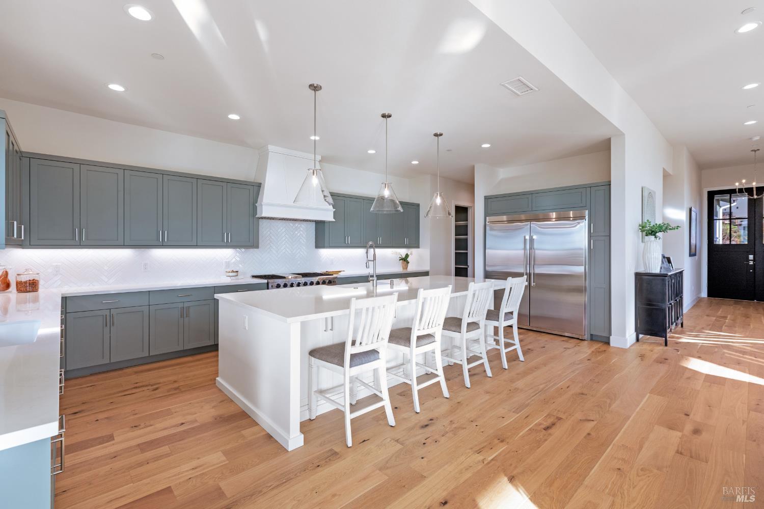 3945 Parker Hill Road Santa Rosa, CA 95404 - Photo 23 of 53 a kitchen with stainless steel appliances kitchen island granite countertop a table chairs sink and cabinets