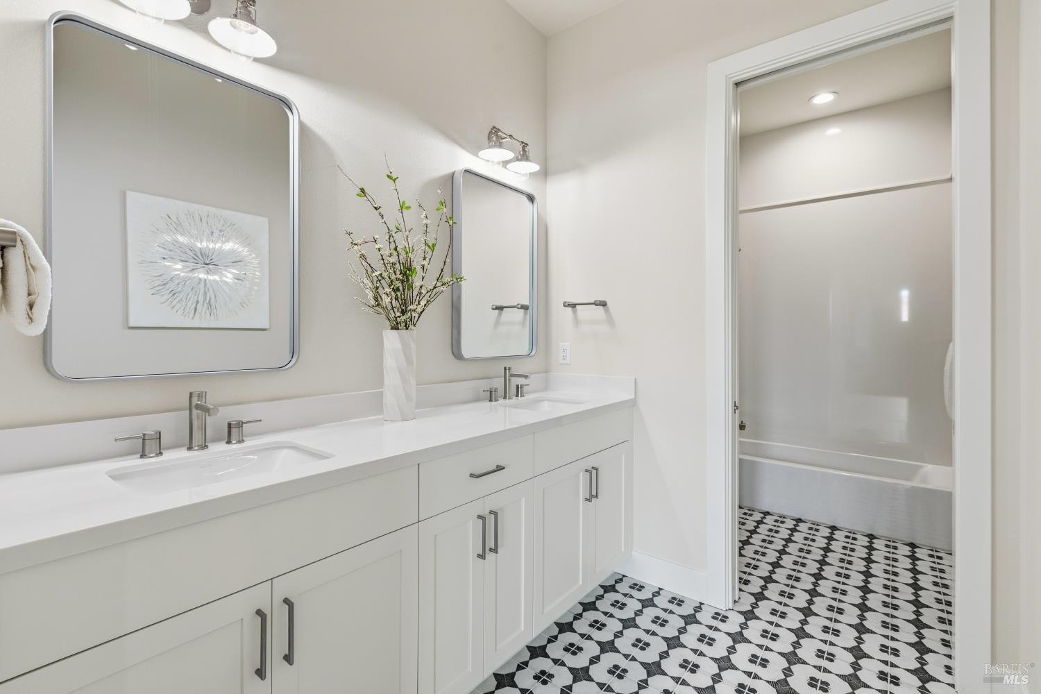 3945 Parker Hill Road Santa Rosa, CA 95404 - Photo 32 of 53 a bathroom with a double vanity sink a mirror and a shower