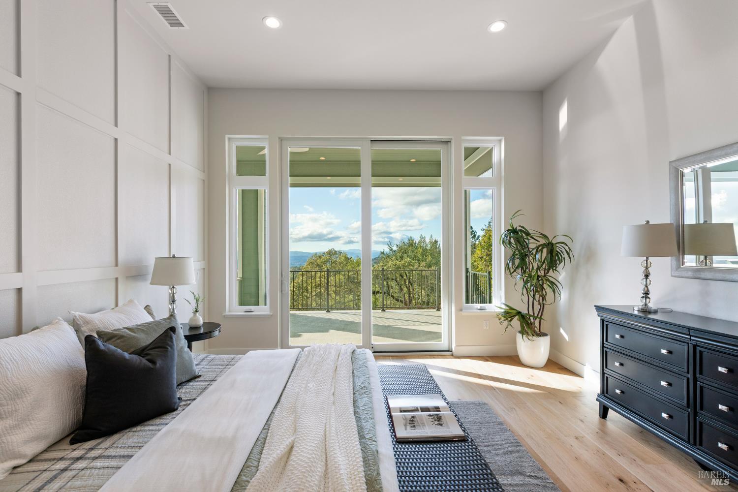 3945 Parker Hill Road Santa Rosa, CA 95404 - Photo 34 of 53 a bedroom with a bed and large windows