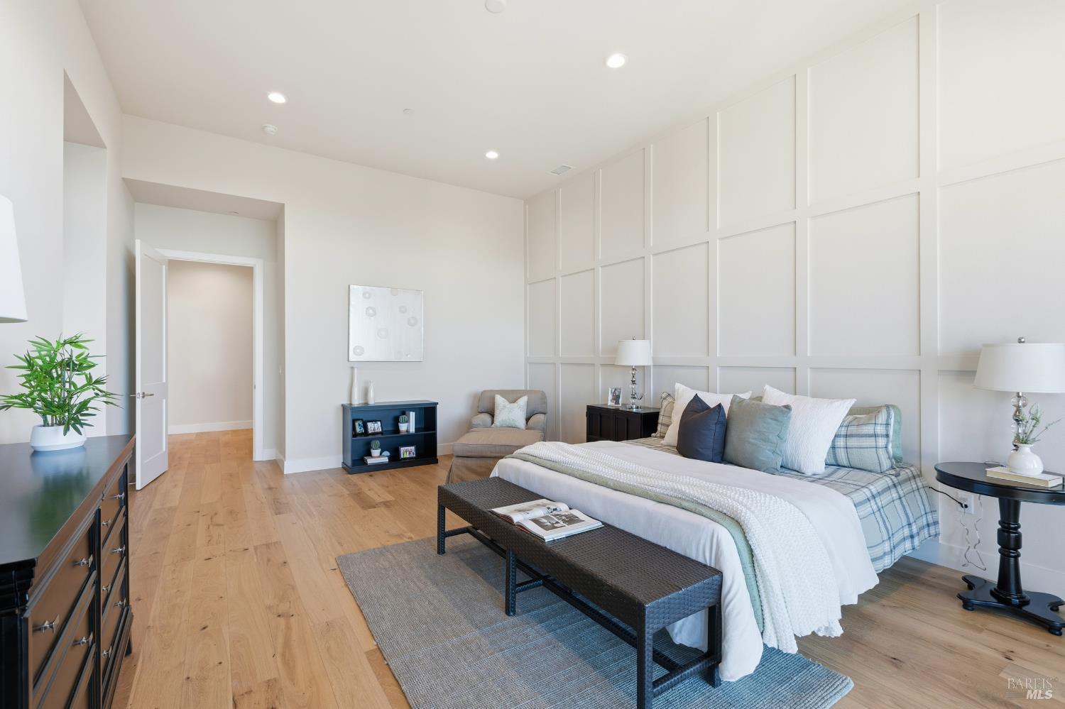 3945 Parker Hill Road Santa Rosa, CA 95404 - Photo 41 of 53 a spacious bedroom with a bed a table and potted plant