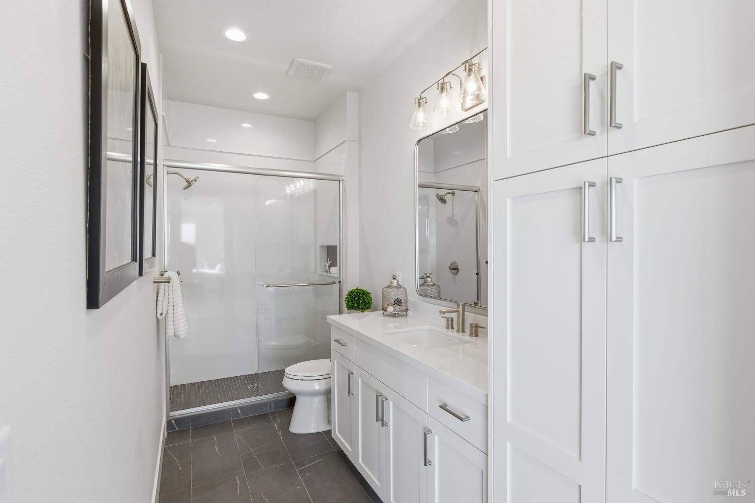 3945 Parker Hill Road Santa Rosa, CA 95404 - Photo 51 of 53 a bathroom with a double vanity sink toilet and shower