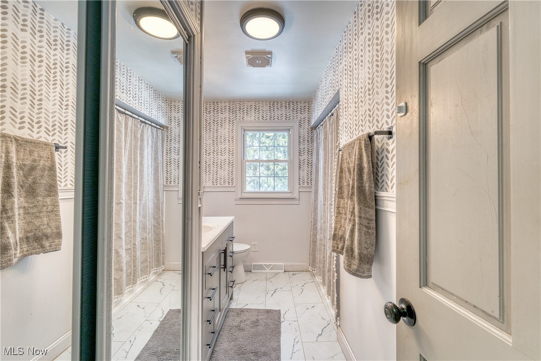 6160 Dresden Road Zanesville, OH 43701 - Photo 20 of 32 Bathroom with a shower with shower curtain, vanity, wallpapered walls, and light marble finish floors