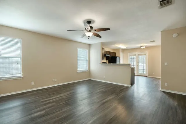 a view of a kitchen with wooden floor and a kitchen