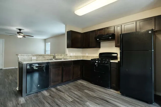 a kitchen with a refrigerator and a sink