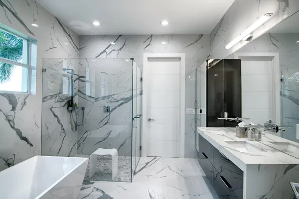 a spacious bedroom with a bed and a flat screen tv