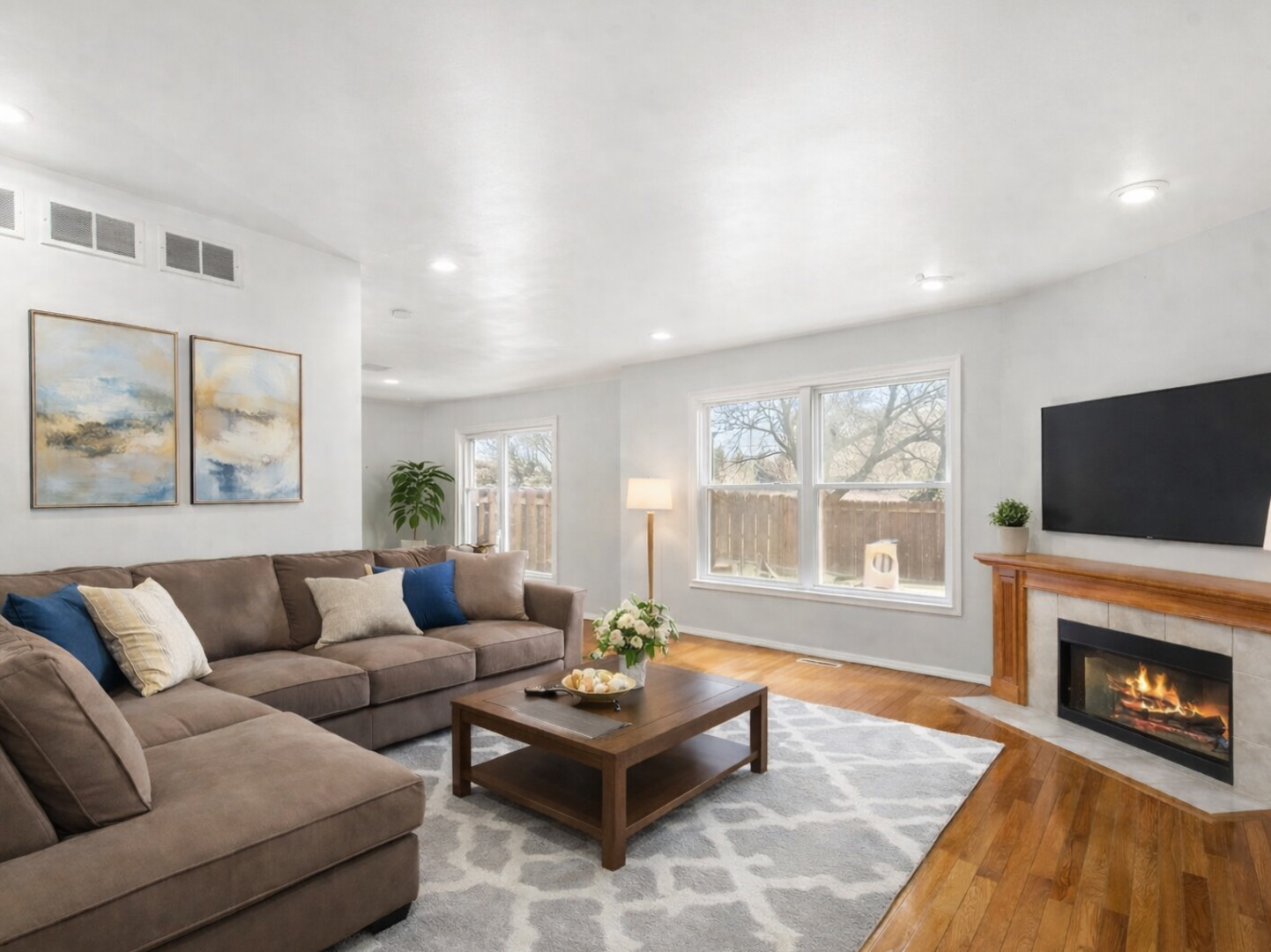 301 Inner Cir Drive Bolingbrook, IL 60490 - Photo 3 of 20 a living room with furniture a flat screen tv and a fireplace