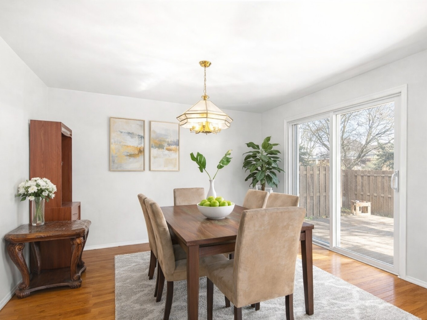 301 Inner Cir Drive Bolingbrook, IL 60490 - Photo 5 of 20 a dining room with furniture wooden floor a rug a potted plant and a chandelier