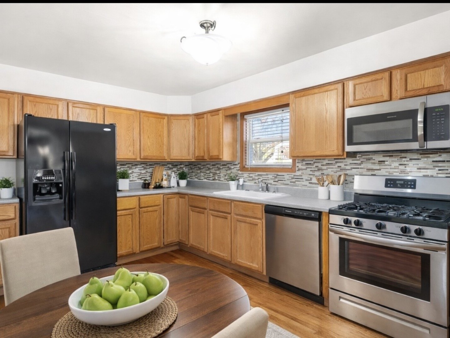 301 Inner Cir Drive Bolingbrook, IL 60490 - Photo 6 of 20 a kitchen with stainless steel appliances granite countertop a stove a sink dishwasher a refrigerator and a microwave