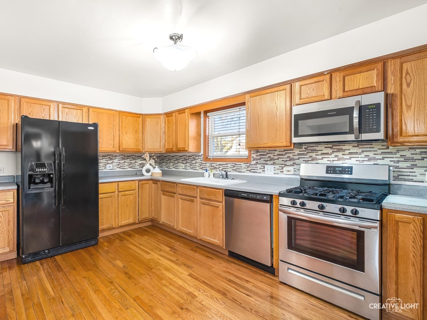 301 Inner Cir Drive Bolingbrook, IL 60490 - Photo 7 of 20 a kitchen with stainless steel appliances granite countertop a stove refrigerator sink and microwave