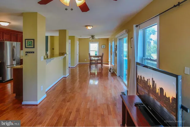 a view of a hallway with wooden floor windows