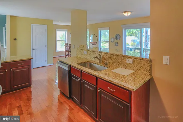 a bathroom with a granite countertop sink and a large mirror