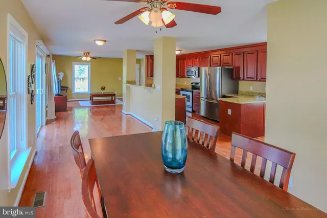 a dining room with furniture and wooden floor