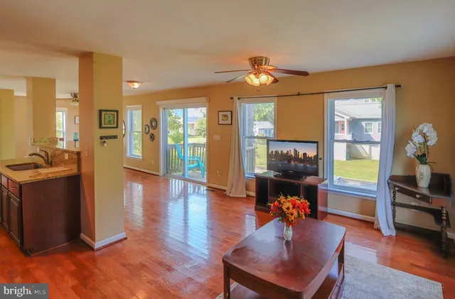 a view of a livingroom with furniture hardwood floor and a workspace
