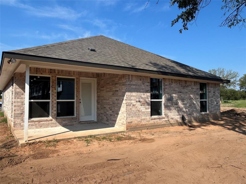 412 Conway Street Waco, TX 76705 - Photo 2 of 8 Rear view of house featuring a shingled roof and brick siding