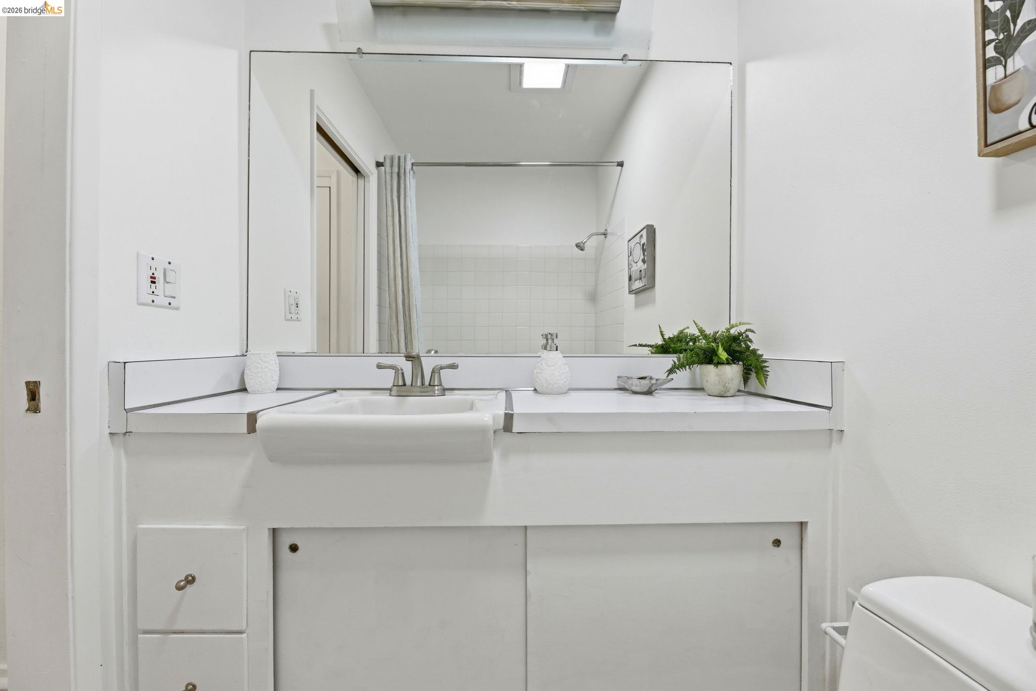 2634 Virginia Street, Unit 33 Berkeley, CA 94709 - Photo 17 of 31 a bathroom with a sink and a mirror