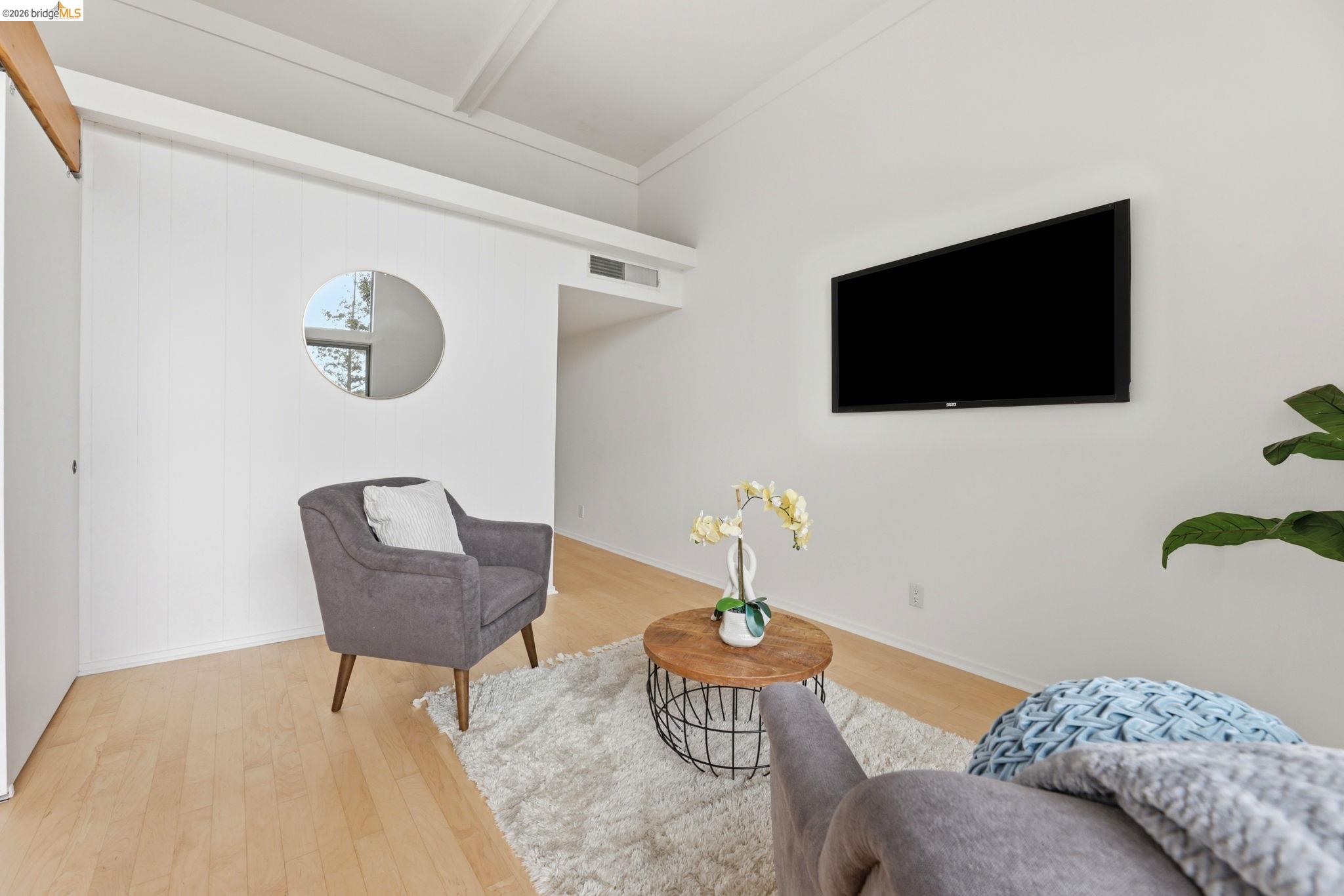 2634 Virginia Street, Unit 33 Berkeley, CA 94709 - Photo 8 of 31 a bedroom with a bed and a flat screen tv