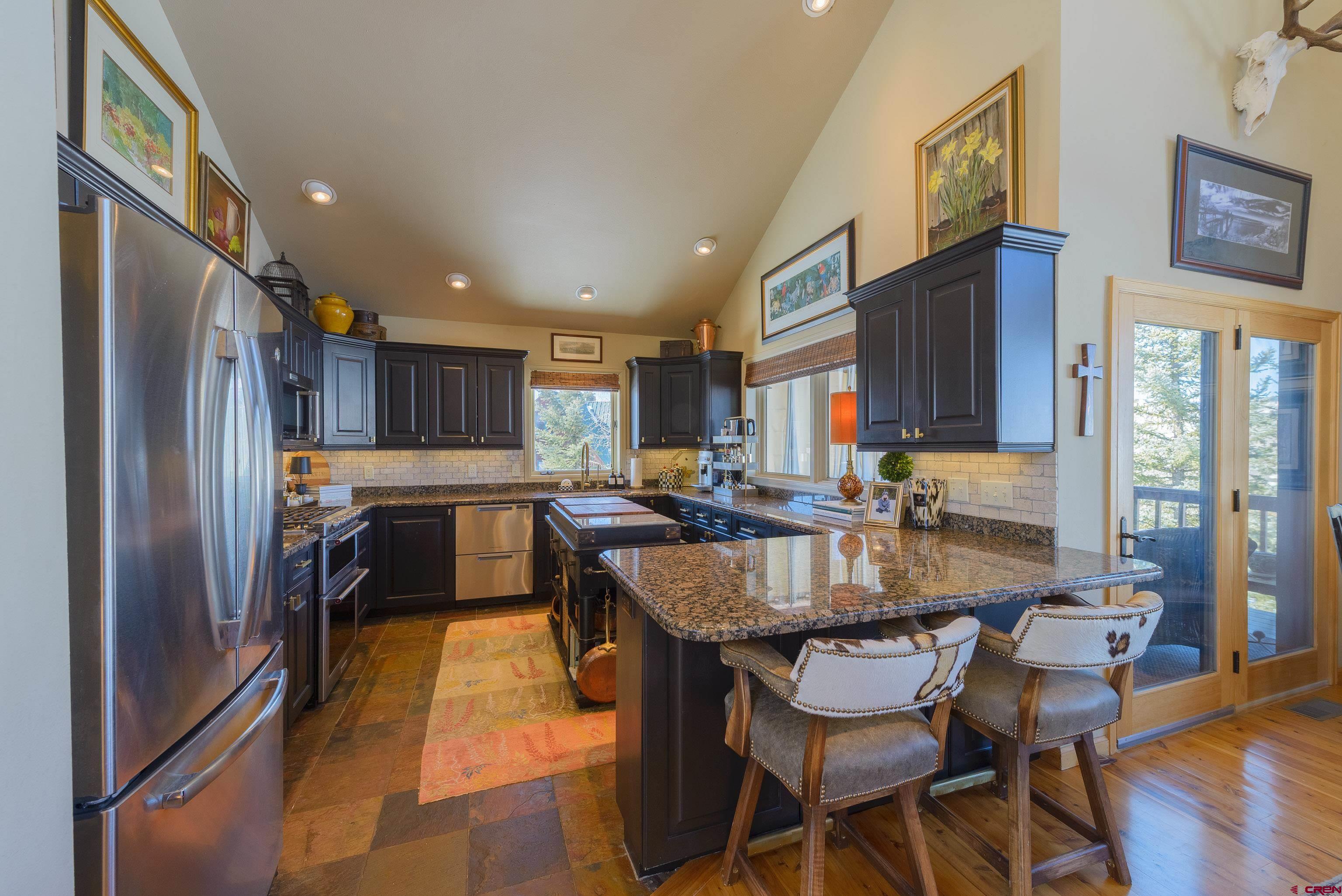 14 Ruby Drive Crested Butte, CO 81225 - Photo 12 of 44 a dining room with kitchen island granite countertop furniture and a refrigerator