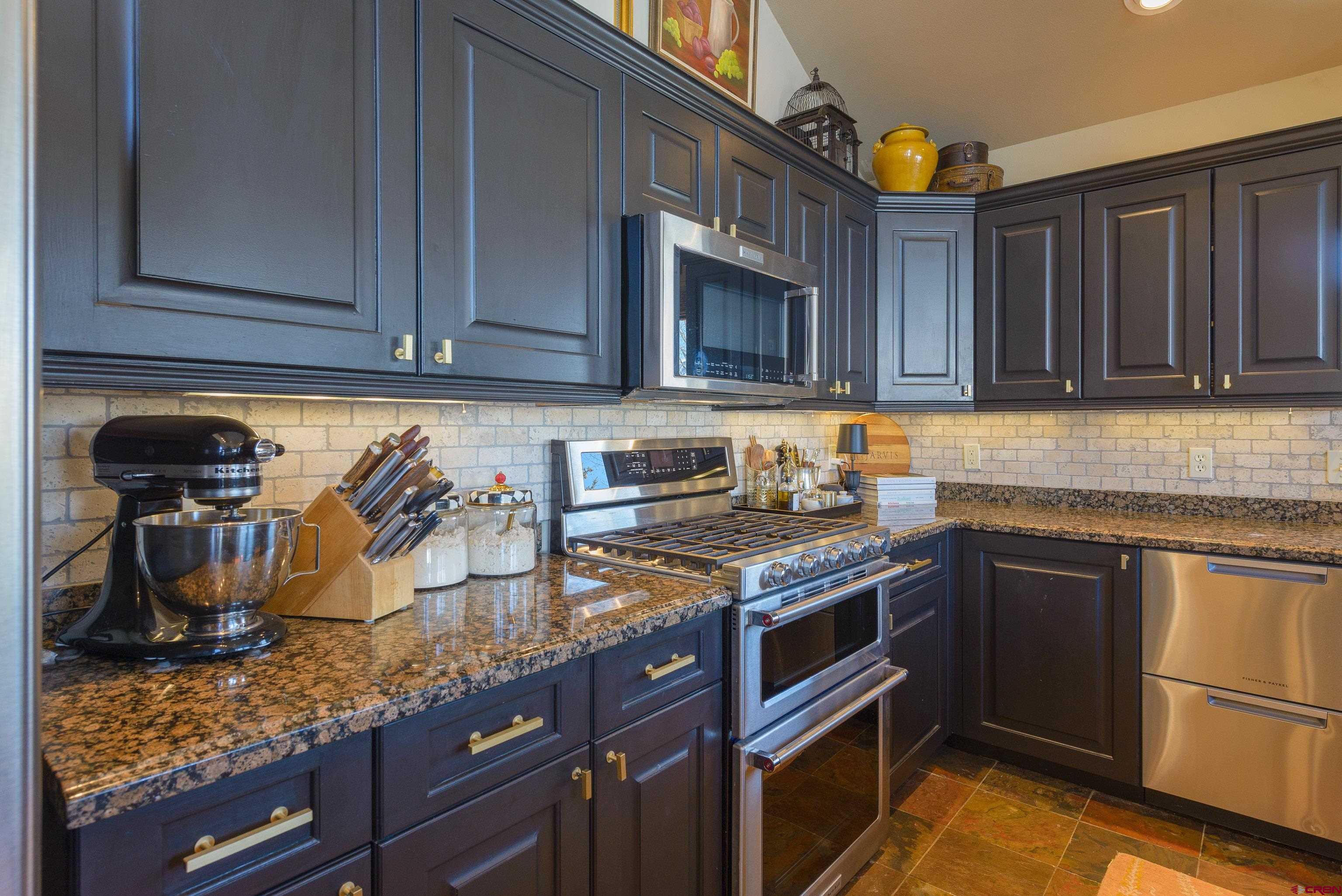 14 Ruby Drive Crested Butte, CO 81225 - Photo 13 of 44 a kitchen with stainless steel appliances granite countertop a sink stove and cabinets