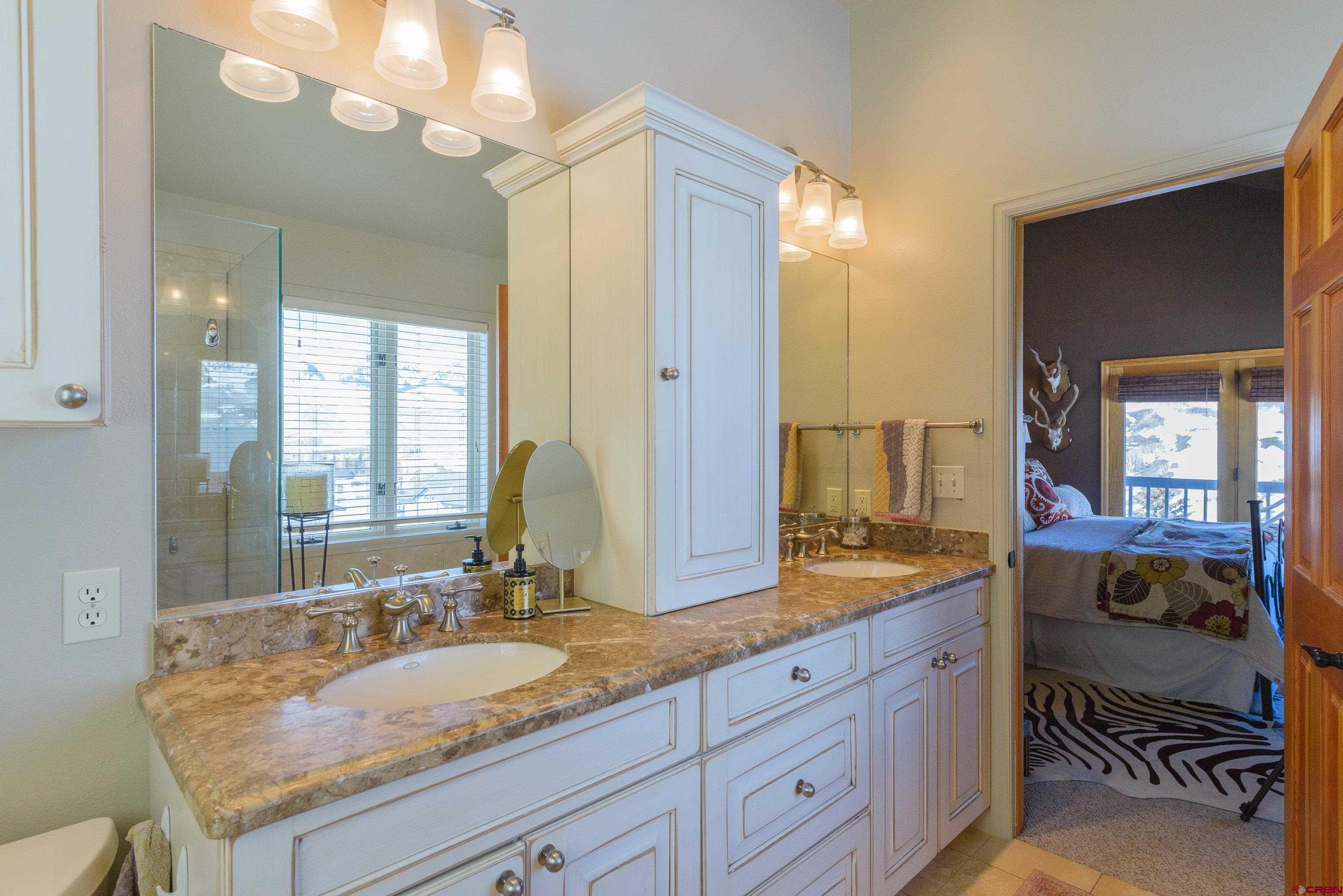 14 Ruby Drive Crested Butte, CO 81225 - Photo 20 of 44 a bathroom with a granite countertop sink and a mirror