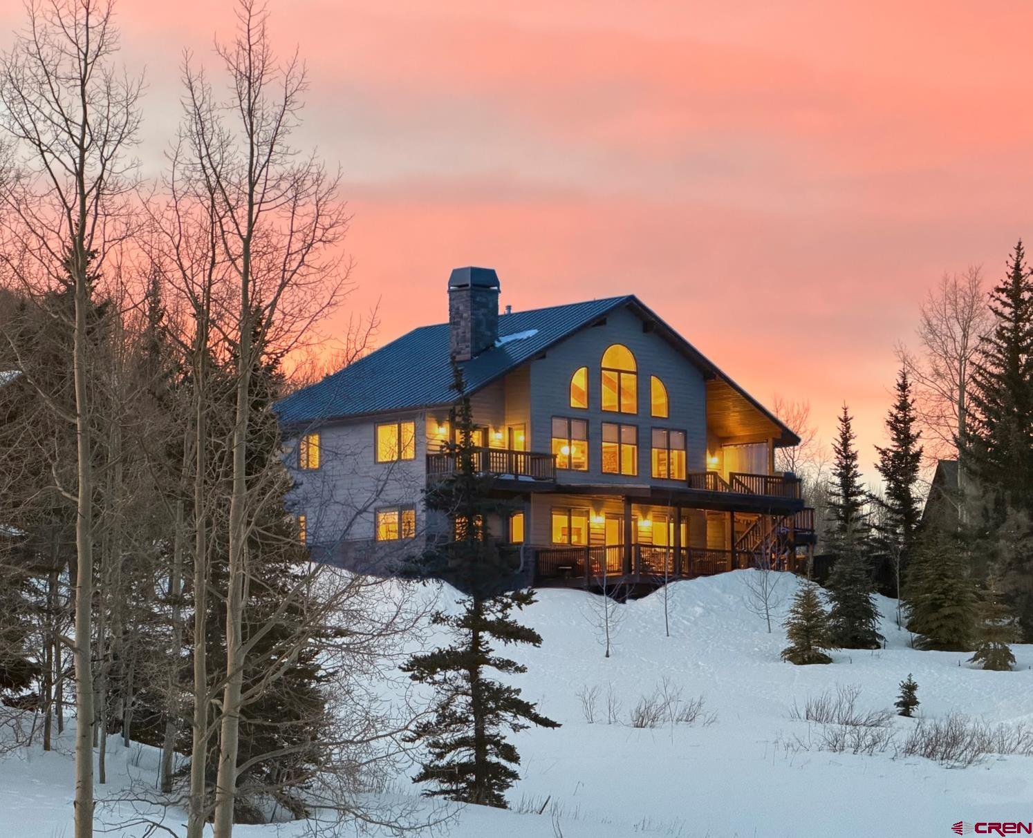 14 Ruby Drive Crested Butte, CO 81225 - Photo 3 of 44 a front view of a house with a yard covered in snow