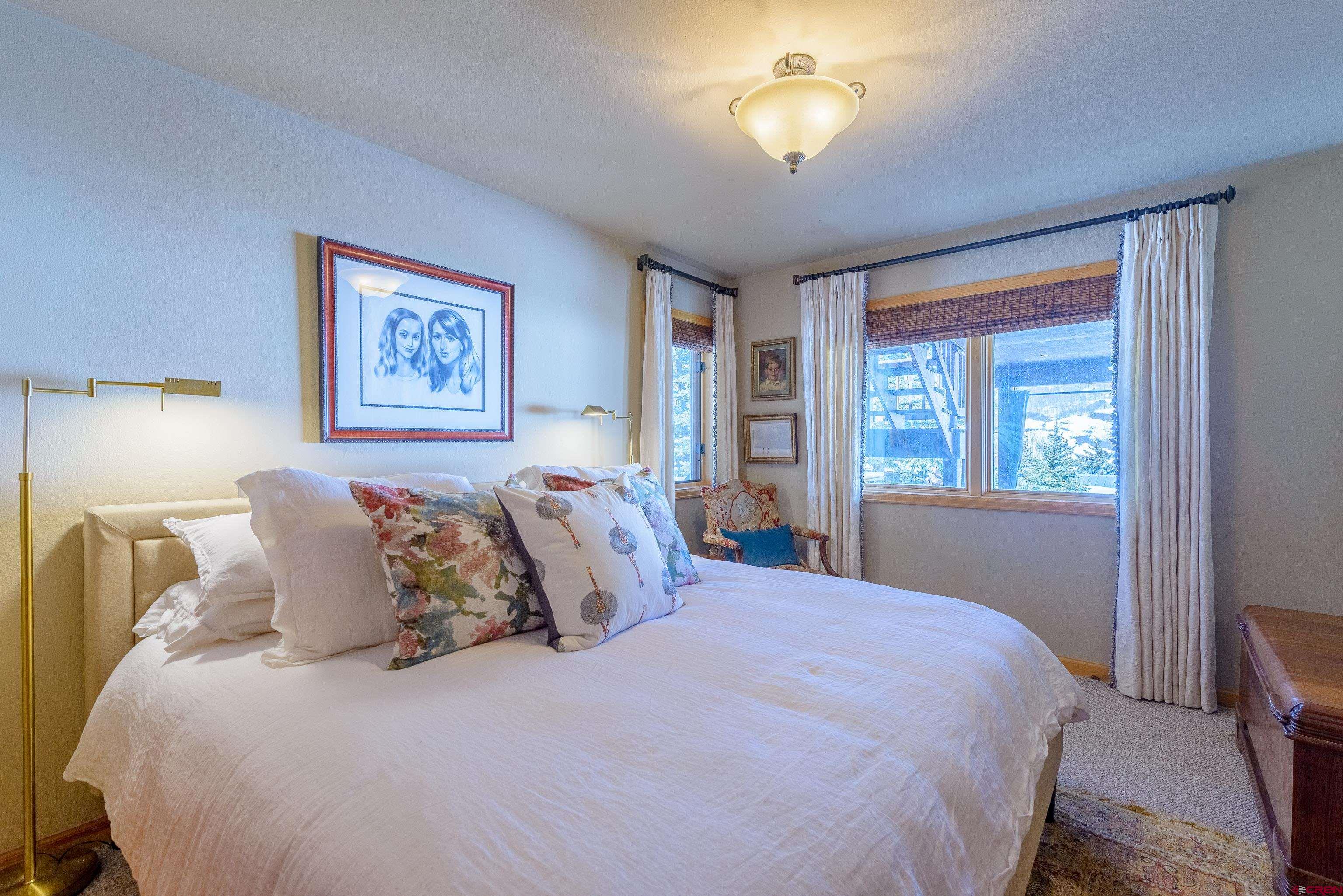 14 Ruby Drive Crested Butte, CO 81225 - Photo 32 of 44 a large bed sitting in a bedroom next to a window