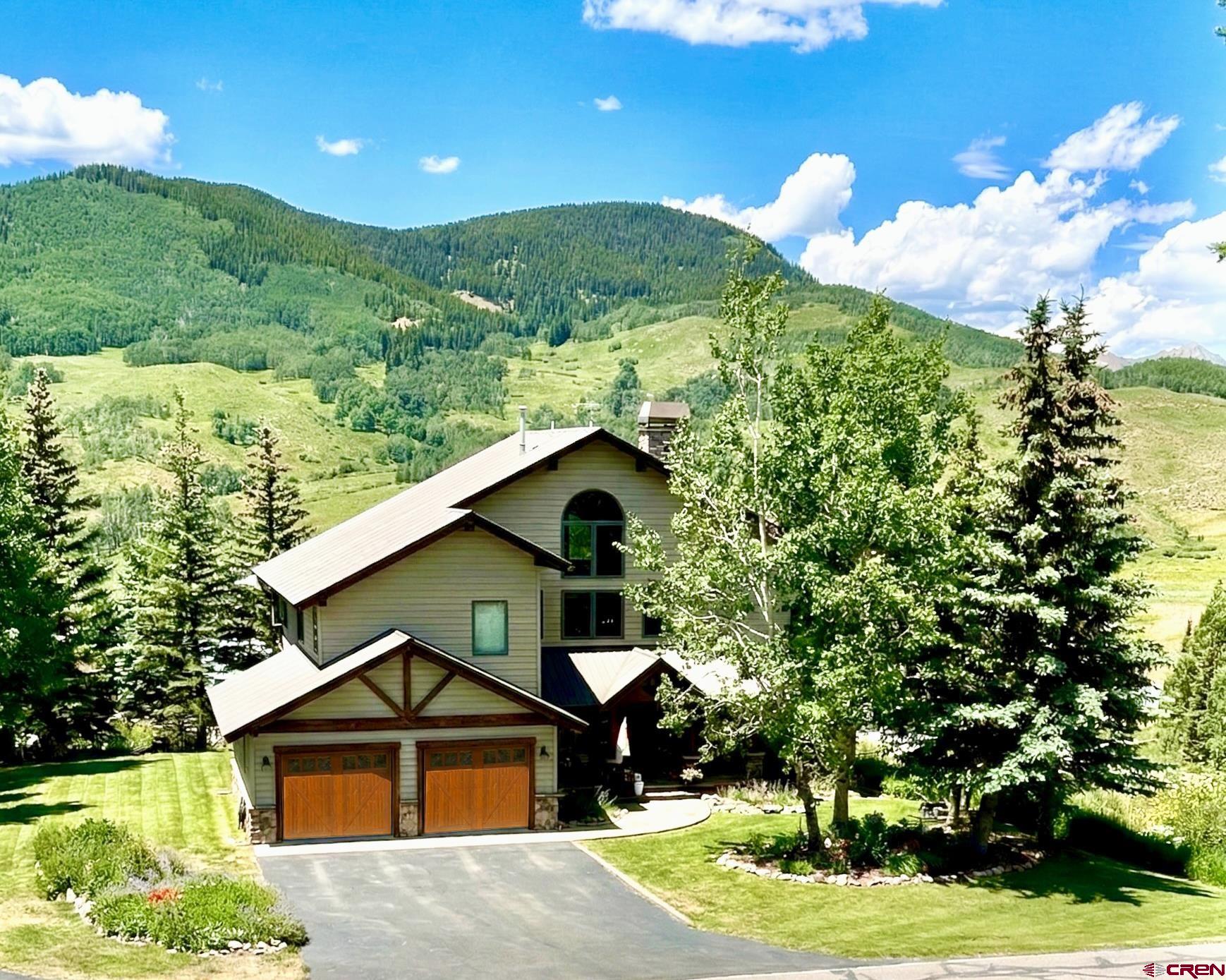 14 Ruby Drive Crested Butte, CO 81225 - Photo 5 of 44 a front view of a house with a yard and potted plants