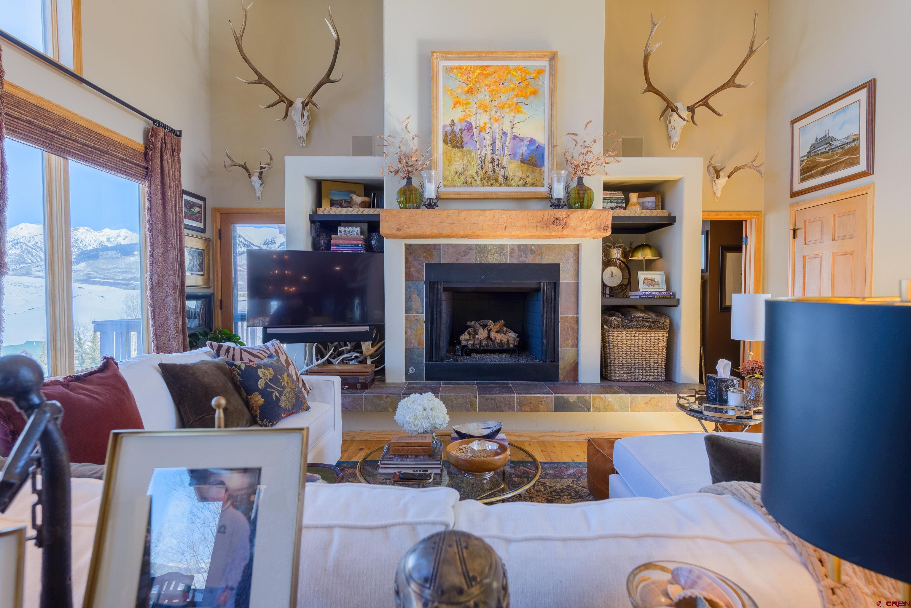 14 Ruby Drive Crested Butte, CO 81225 - Photo 10 of 44 a living room with furniture a fireplace and a large window