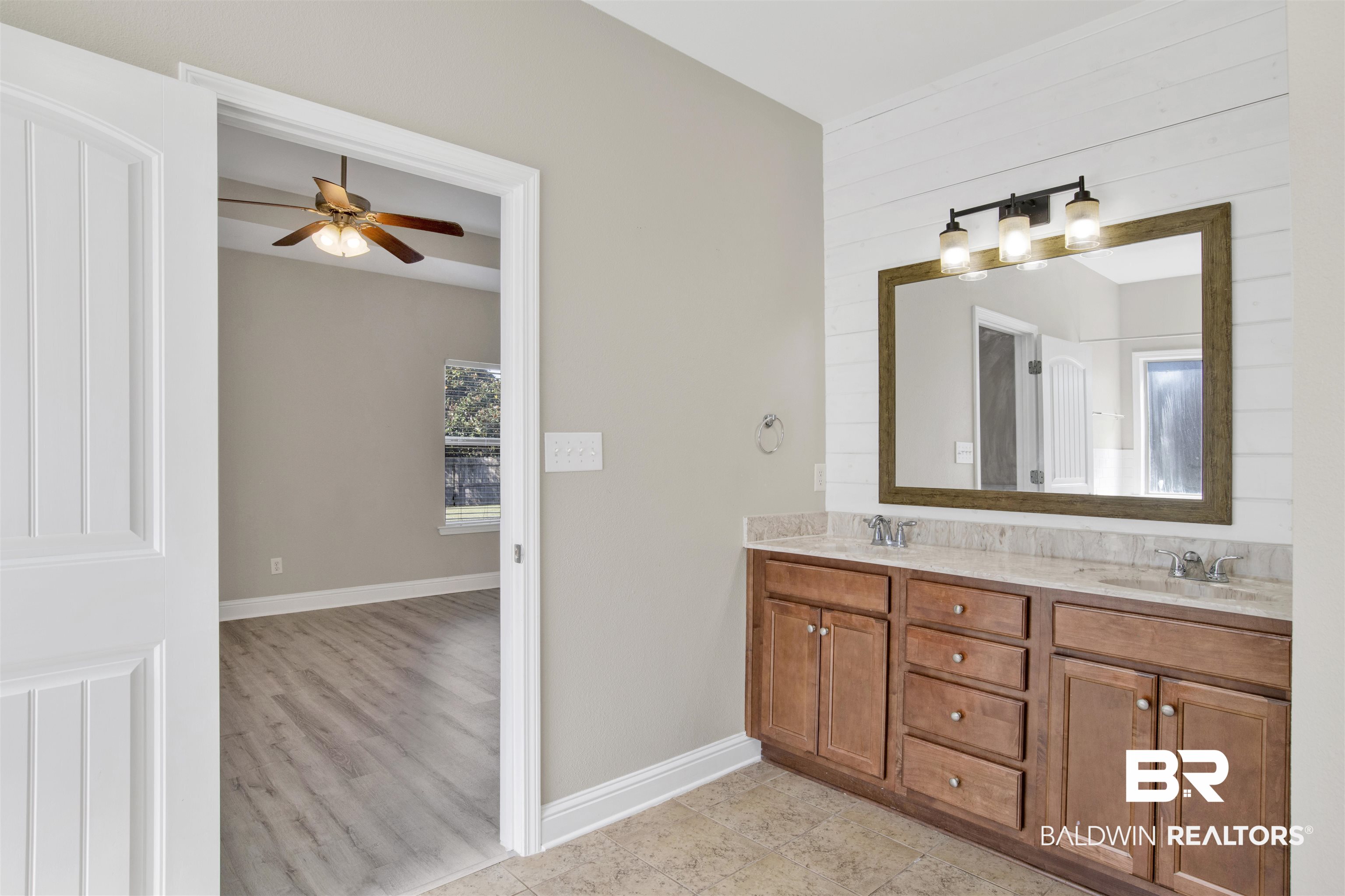 24159 Tullamore Drive Daphne, AL 36526 - Photo 24 of 31 Bathroom featuring vanity, wood walls, hardwood / wood-style flooring, and ceiling fan
