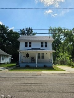 819 Keeney Street Akron, OH 44310 - Photo 1 of 24 White two-story residence with a covered front porch featuring white railings