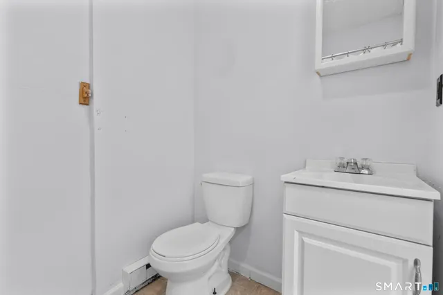 a bathroom with a toilet sink and vanity