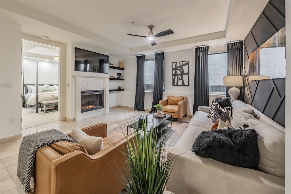 a living room with furniture fireplace and a window