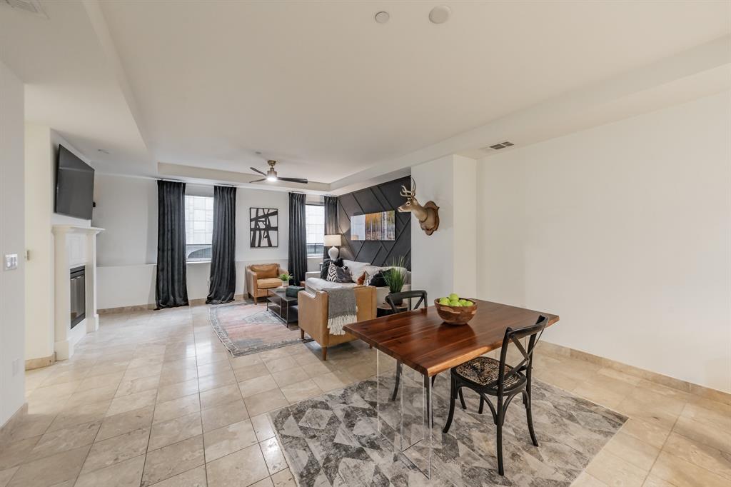 1505 Elm Street, Unit 404 Dallas, TX 75201 - Photo 11 of 40 a living room with furniture and a table