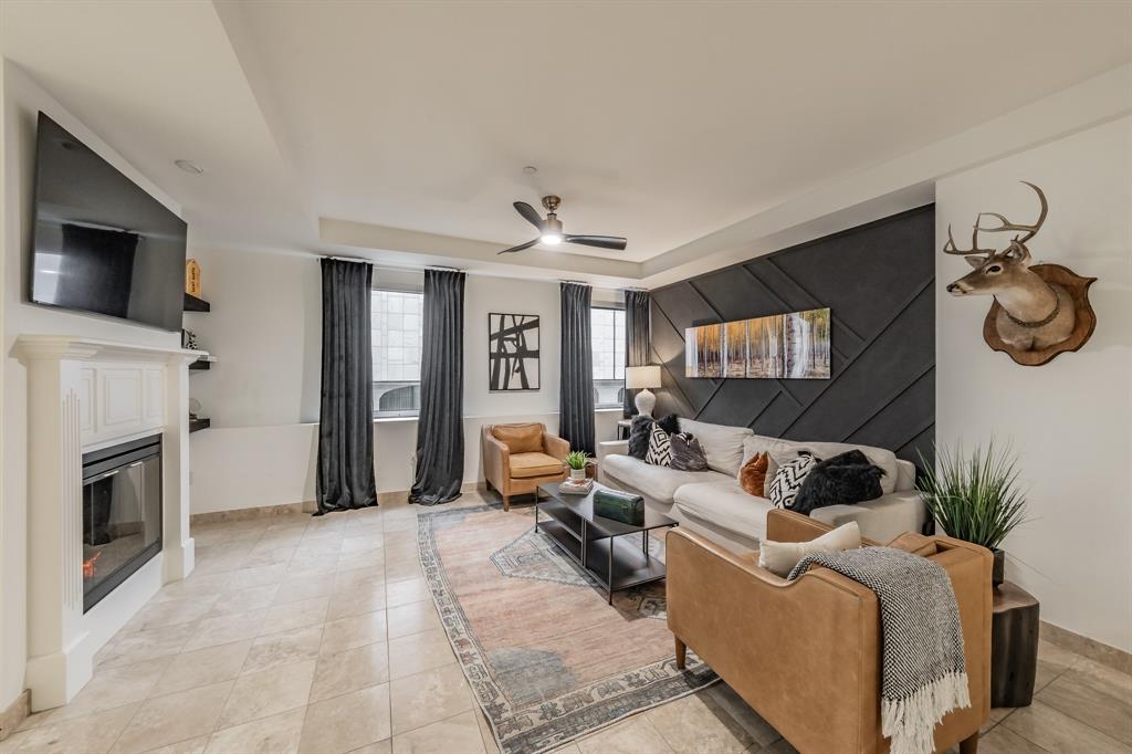1505 Elm Street, Unit 404 Dallas, TX 75201 - Photo 13 of 40 a living room with furniture and a flat screen tv