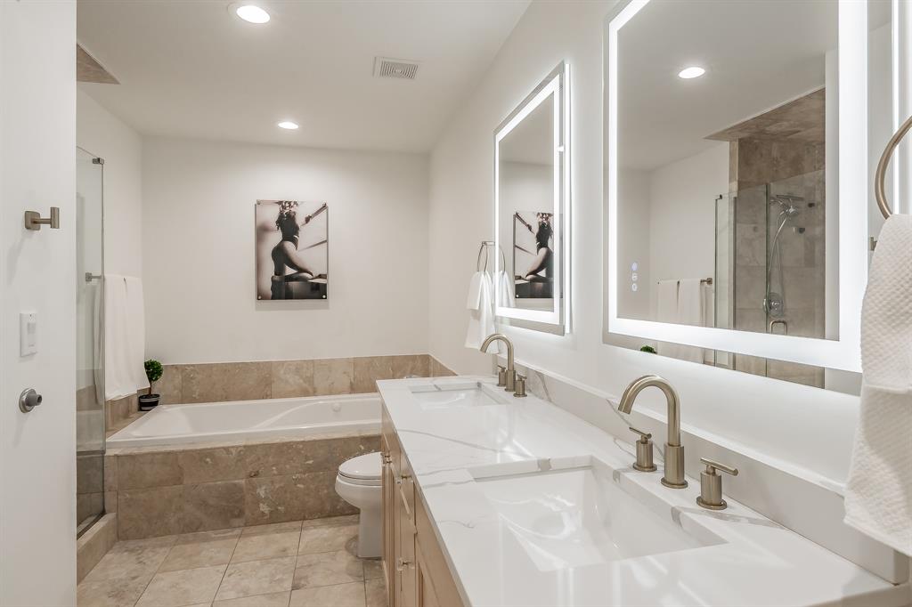 1505 Elm Street, Unit 404 Dallas, TX 75201 - Photo 18 of 40 a bathroom with a tub a sink and mirror