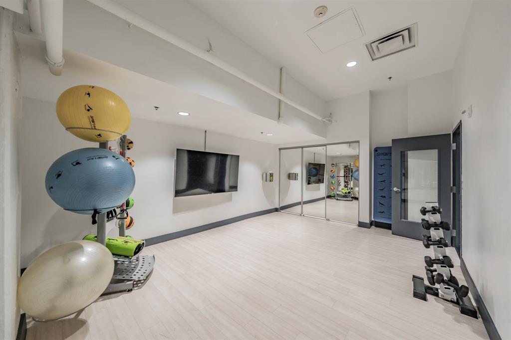1505 Elm Street, Unit 404 Dallas, TX 75201 - Photo 25 of 40 a living room with furniture and a mirror