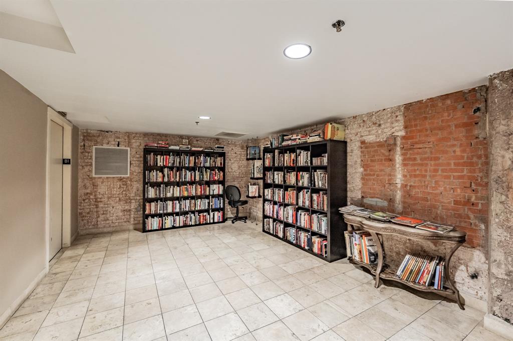 1505 Elm Street, Unit 404 Dallas, TX 75201 - Photo 30 of 40 a view of an empty room with racks on the wall