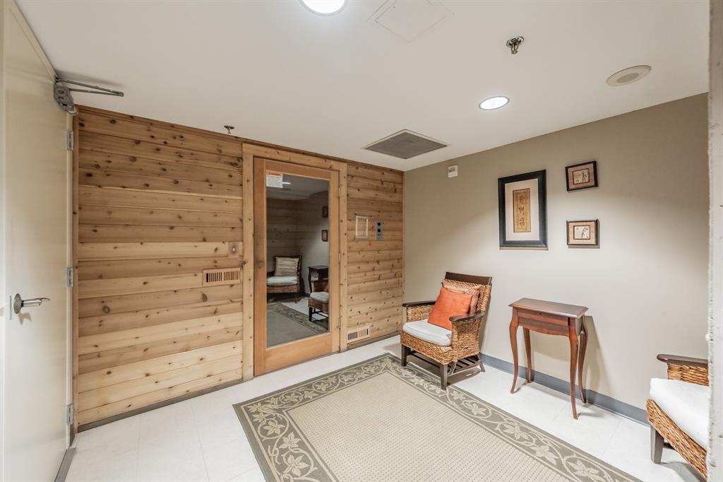 1505 Elm Street, Unit 404 Dallas, TX 75201 - Photo 31 of 40 a living room with furniture and a dresser