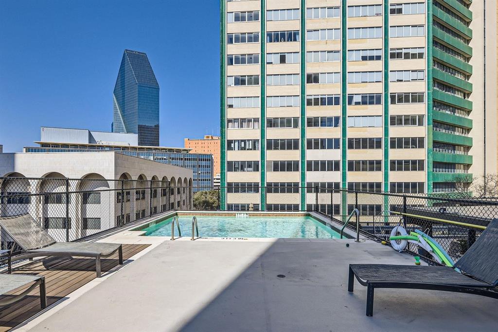 1505 Elm Street, Unit 404 Dallas, TX 75201 - Photo 33 of 40 a living room with furniture and a floor to ceiling window