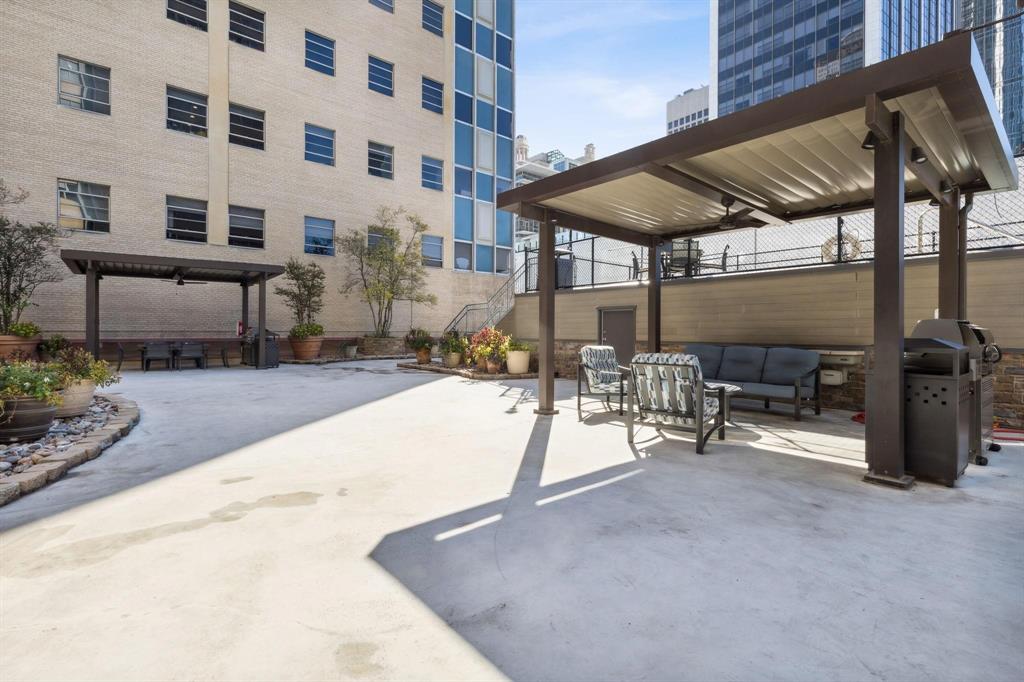 1505 Elm Street, Unit 404 Dallas, TX 75201 - Photo 35 of 40 a view of a chairs and table in patio