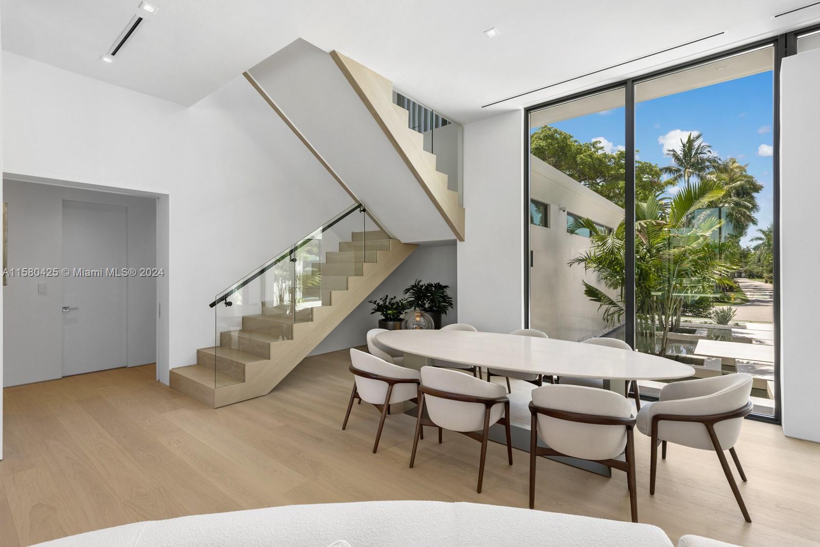 2700 Sunset Drive Miami Beach, FL 33140 - Photo 21 of 40 a view of a dining room with furniture and wooden floor