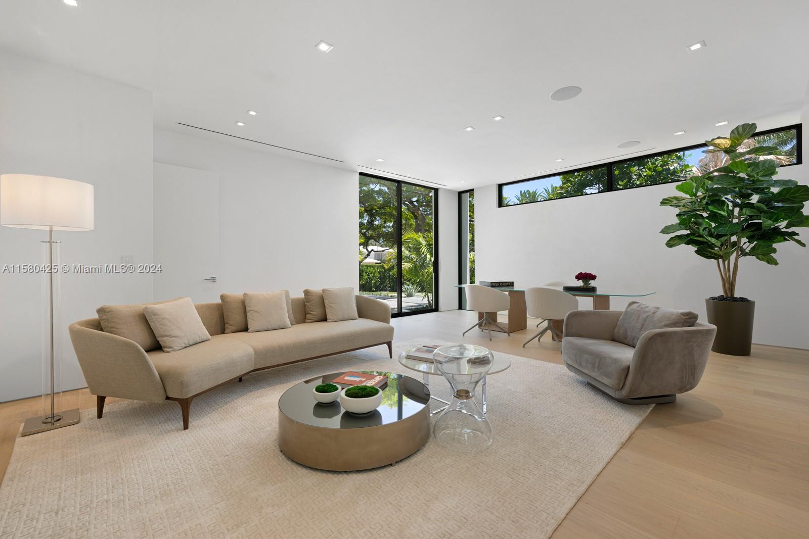 2700 Sunset Drive Miami Beach, FL 33140 - Photo 22 of 40 a living room with furniture potted plant and a large window