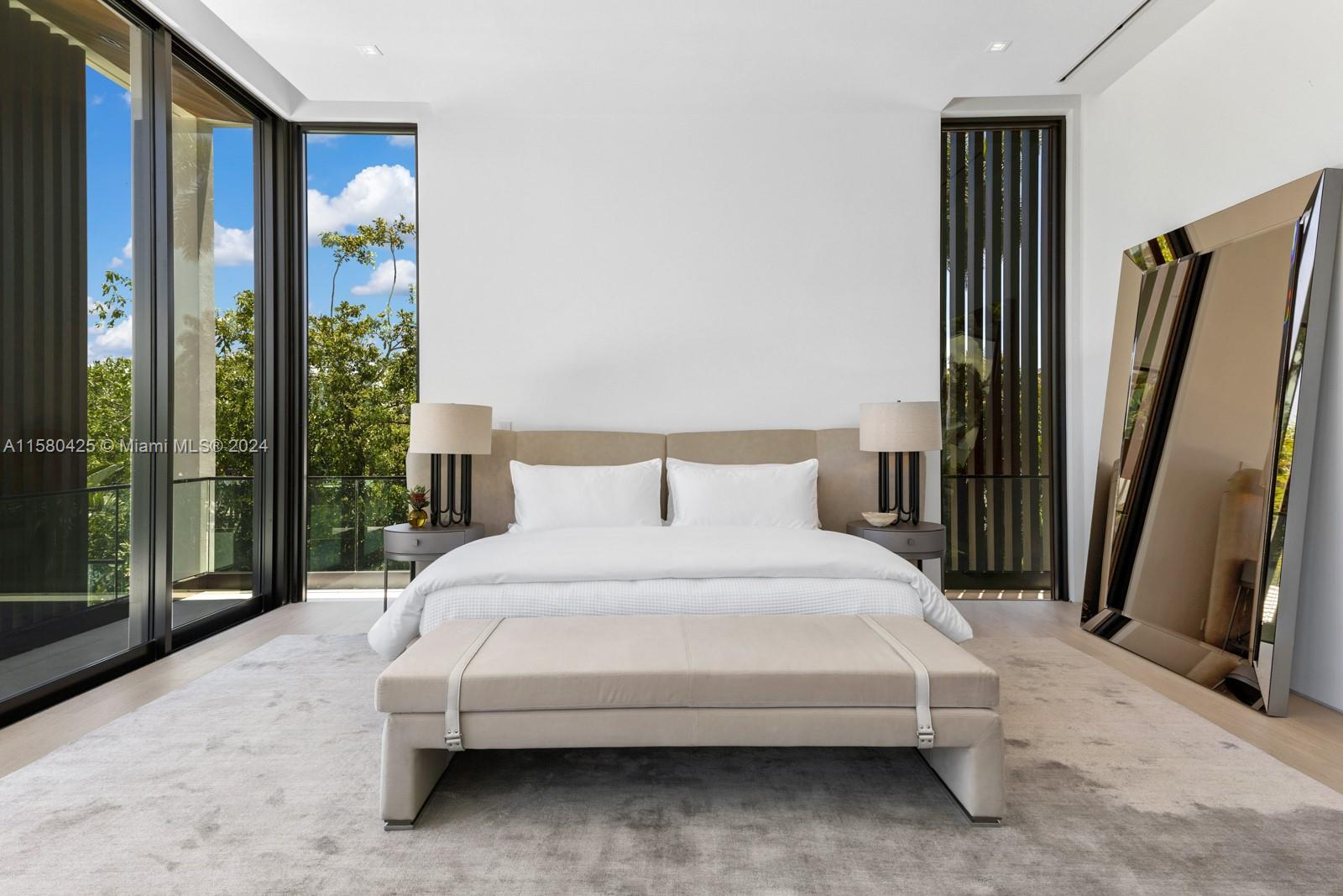 2700 Sunset Drive Miami Beach, FL 33140 - Photo 28 of 40 a bedroom with a bed flat screen tv and a large window